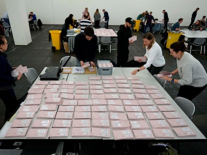 Volunteers prepare postal votes during the German national election in Munich, Germany, Sunday, Feb. 23, 2025. (AP Photo/Matthias Schrader)