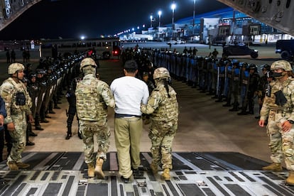 iubbt6jpnoyipivvt4qsd5yksq U.S. military personnel escort an alleged gang member who was deported by the U.S. along with others the U.S. alleges are members of the Venezuelan gang Tren de Aragua and the MS-13 gang to be imprisoned in the Terrorism Confinement Center (CECOT) prison, at the El Salvador International Airport in San Luis Talpa, El Salvador April 12, 2025